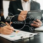 Web hosting concept, business using computer and presses his finger on the virtual screen inscription Hosting on desk, Internet, business, Technology and network concept.